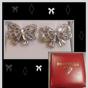 Bow shaped earrings with created diamond simulants.