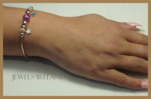 Rosegold  bracelet with shimmering balls and charms.